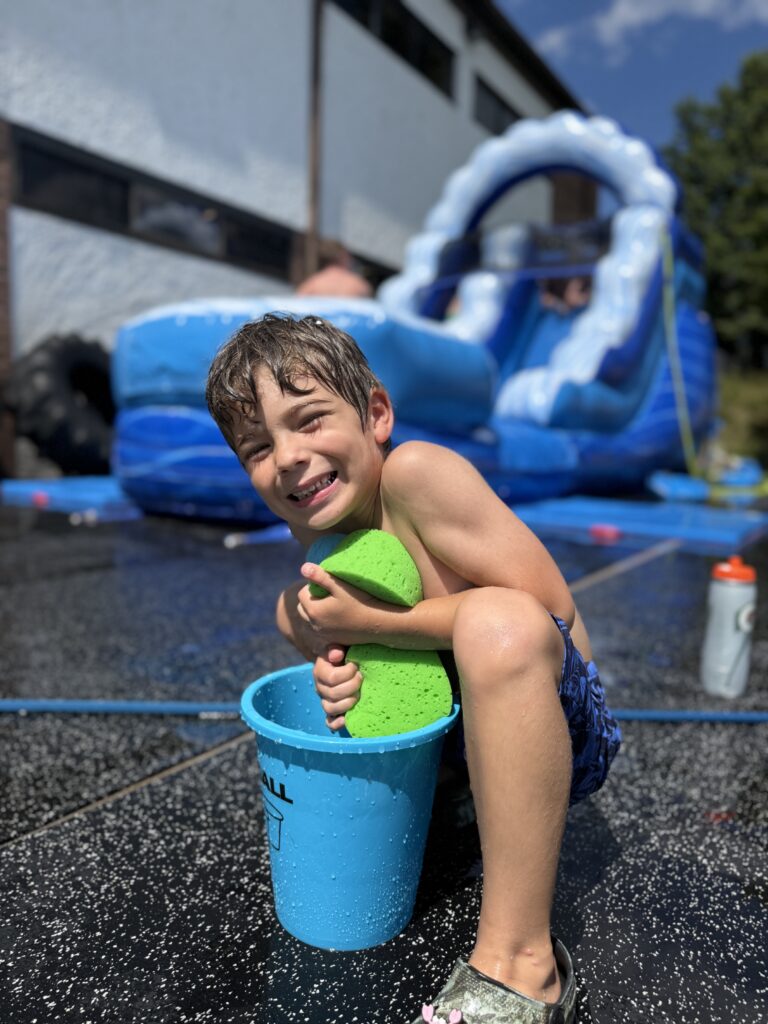 kid at camp at water slide